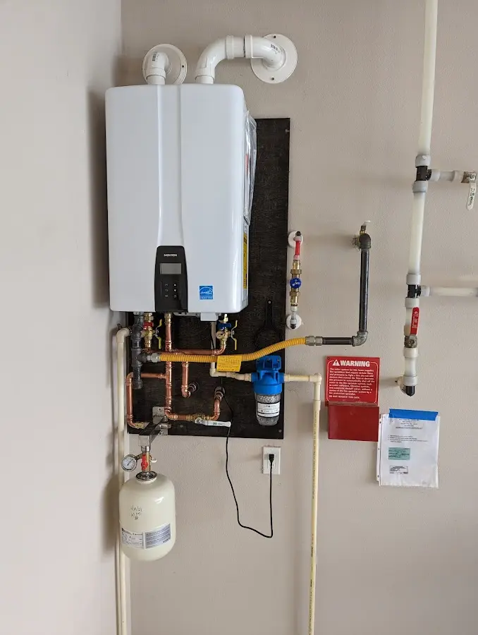 Professional plumber installing copper piping in a Rock Springs home